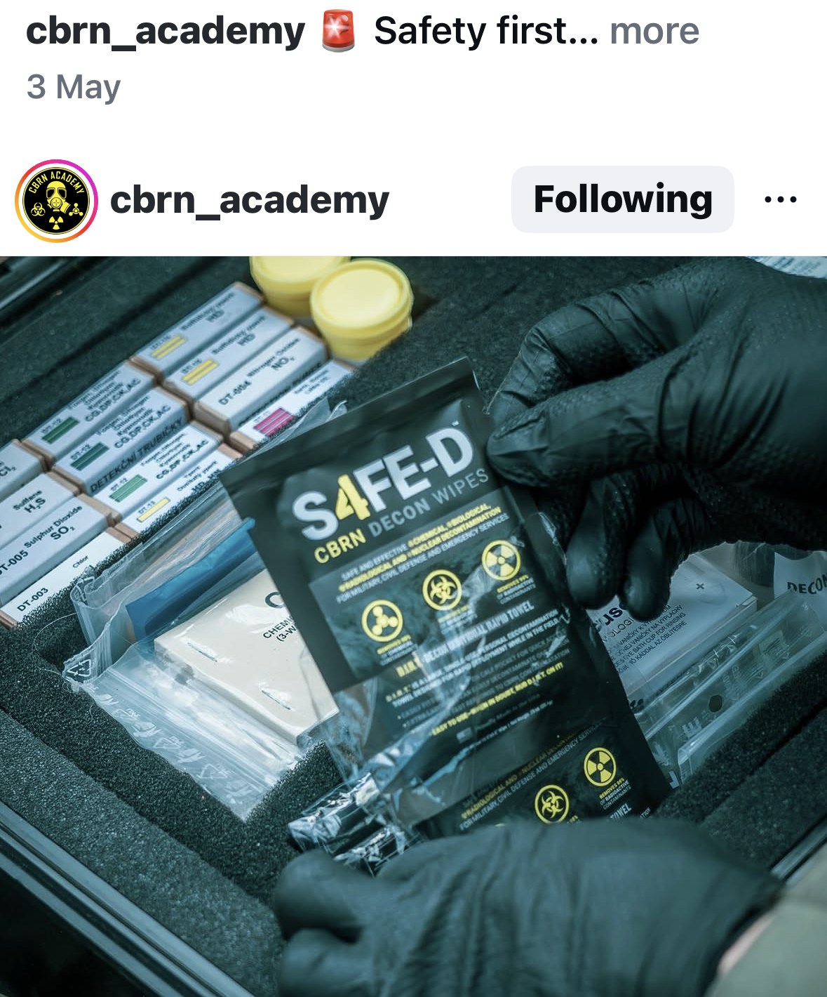 Black tactical gloves placing an S4FE-D CBRN Decon Wipes pouch into a hardshell CBRN gear kit — posted by CBRN Academy on Instagram with caption 'Now the kit is complete!'