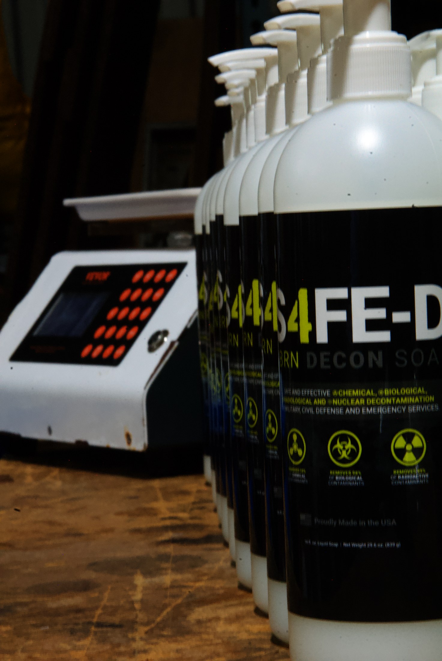 S4FE-D dispenser bottles on the LTI production bench, with the bottling machine in the background — filled in Elburn, Illinois