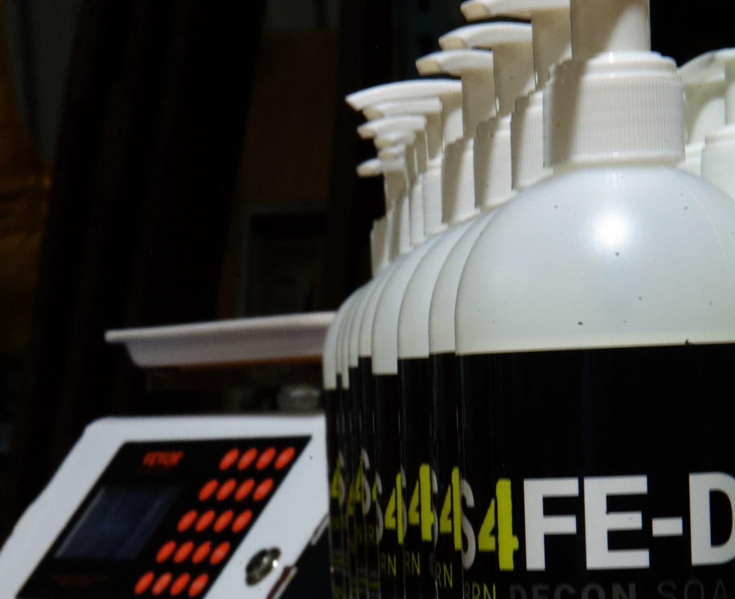 S4FE-D dispenser bottles on the LTI production bench, with the bottling machine in the background — filled in Elburn, Illinois